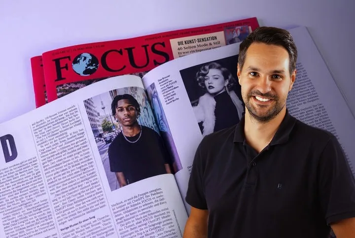 Björn Schneider beside the FOCUS magazine feature on Anyland
